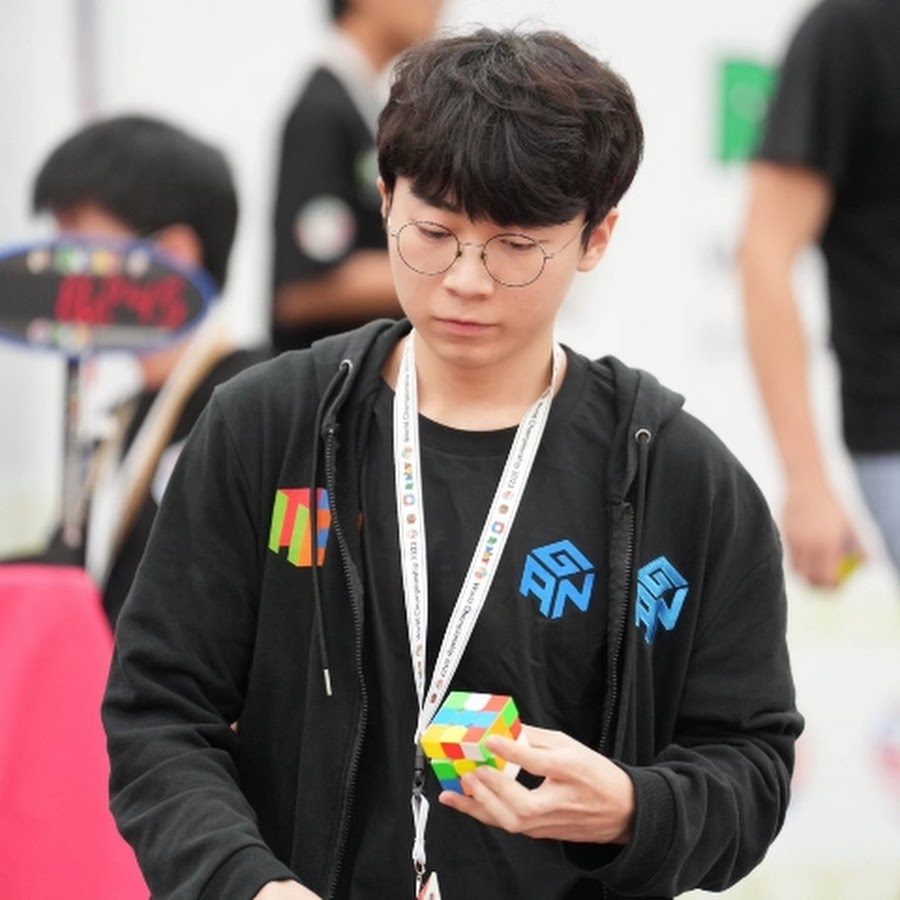 Imagem do competidor Seung Hyuk Nahm, recordista asiático, segurando um cubo mágico 3x3x3 em uma competição